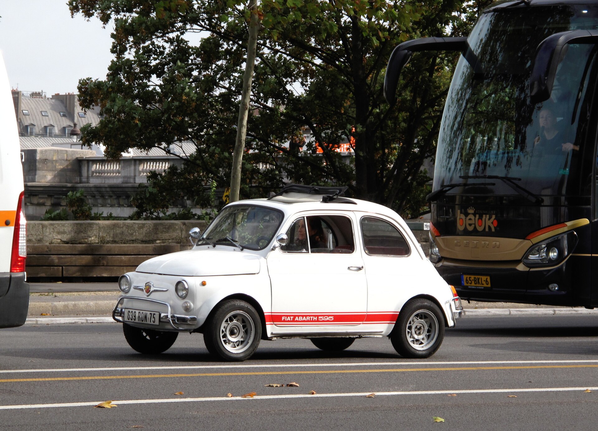 White 1969 Fiat Abarth 595 driving in Paris.