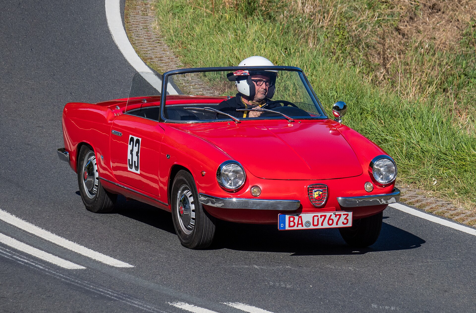 Red 1961 Fiat Abarth Allemano 850 Spider competing at the Würgau hill climb.