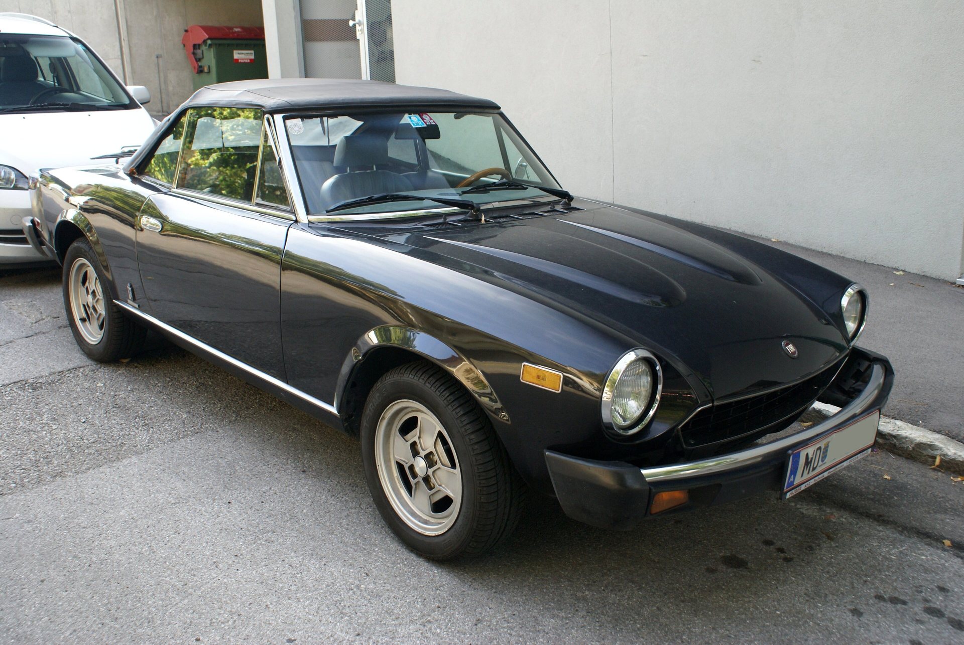 Black classic Fiat 124 Sport Spider.