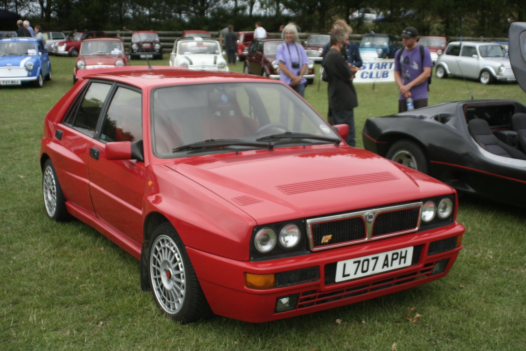 Red Lancia Delta HF Integrale Evoluzione displayed at a car show.